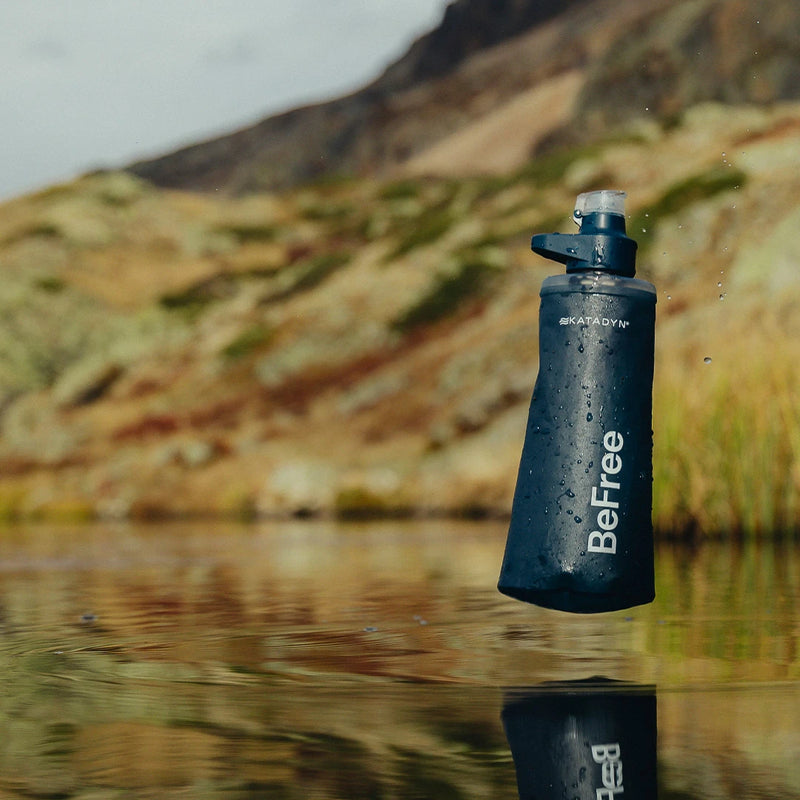roduct shot of a Katadyn BeFree water filter flask featuring HydraPak’s flexible, collapsible soft flask design against a scenic backcountry lake.