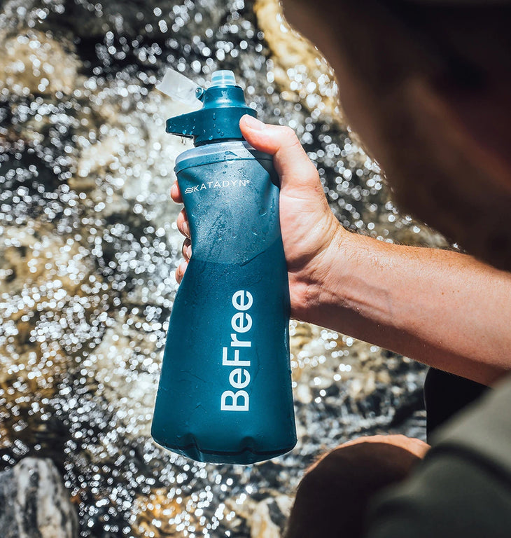 Close-up of the Katadyn BeFree filter system featuring a flexible, collapsible HydraPak soft flask filled with fresh water.